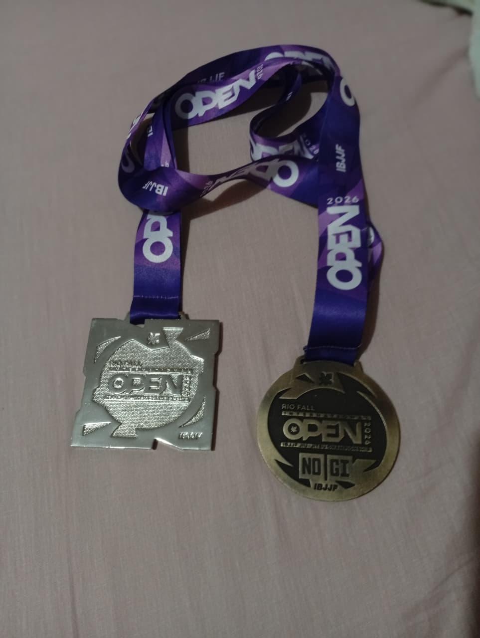 Medalhas de vice-campeão na categoria Master 1 Leve com quimono e terceiro lugar na categoria Master 1 Leve No-Gi (sem quimono).